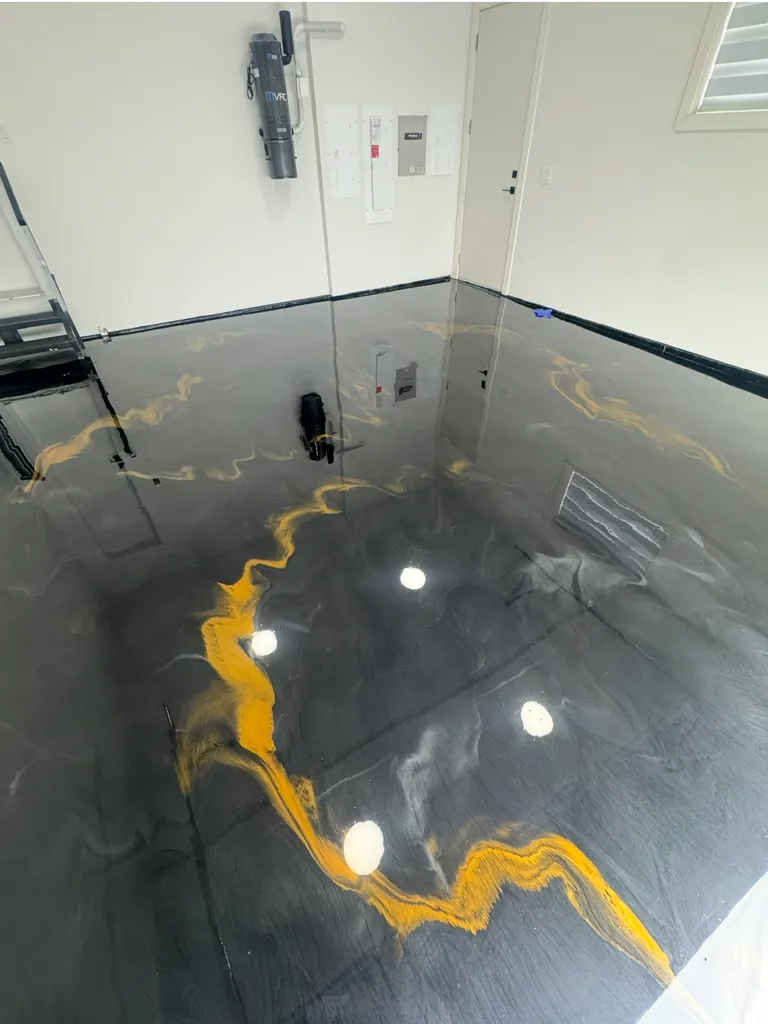 Black and gold metallic epoxy garage floor