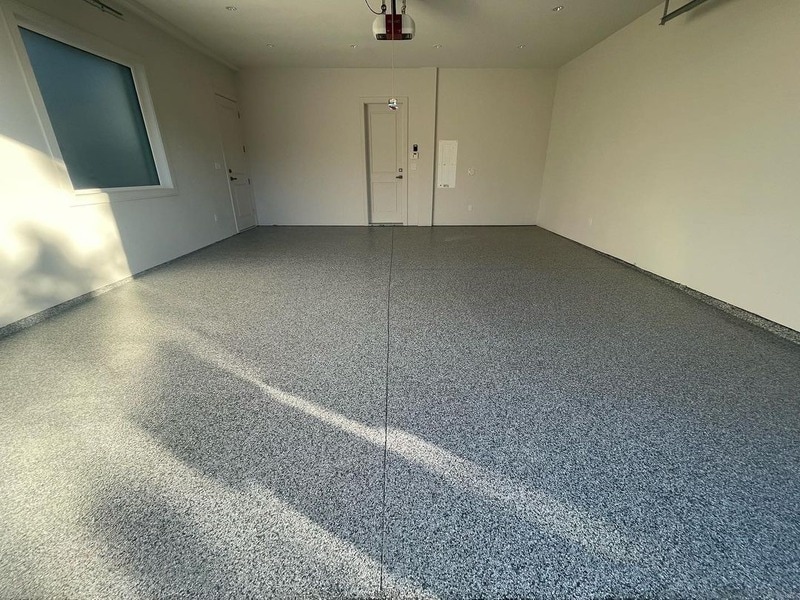 A wide view of marble design epoxy flooring in a garage.